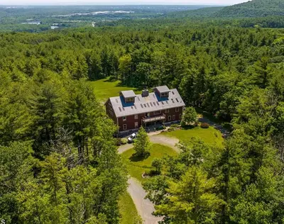an aerial view of a large house in the woods at Moonrise Rest A Historic Mohawk Valley Retreat in Schenectady