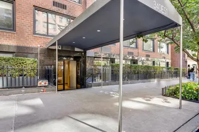 a building with an awning in front of a building at Blueground Midtown East fitness center nr UN NYC-2172 in New York