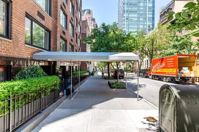 a bus stop with awning on a city street at Blueground Midtown East fitness center nr UN NYC-2172 in New York
