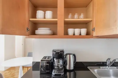 a kitchen with a coffee maker on a counter at Blueground Financial District rooftop nr Brooklyn Bridge NYC-2201 in New York