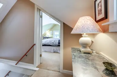 a hallway with a bed and a lamp on a table at Hike, Fish, Hunt! Green Mountain Home By River