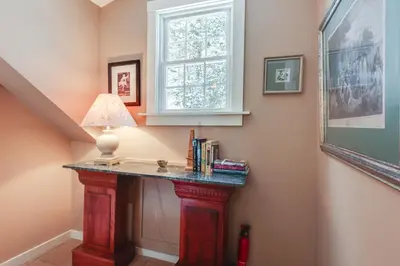 a room with a table with a lamp and a window at Hike, Fish, Hunt! Green Mountain Home By River