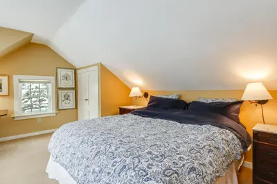 a bedroom with a large bed and a window at Hike, Fish, Hunt! Green Mountain Home By River