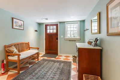 a living room with a chair and a door at Hike, Fish, Hunt! Green Mountain Home By River