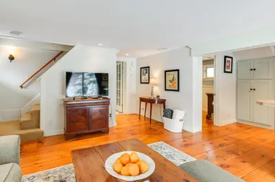 a living room with a bowl of oranges on a table at Hike, Fish, Hunt! Green Mountain Home By River