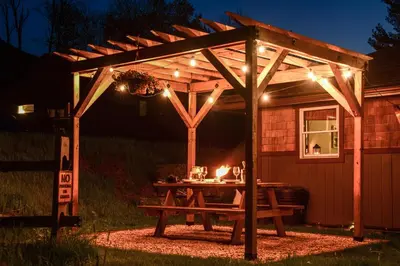 a picnic table under a pergola at night at Villa Gran Sasso in Hunter