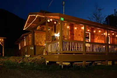 a house with a deck at night with lights at Villa Gran Sasso in Hunter