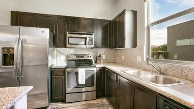 a kitchen with stainless steel appliances and a window at Landing Apartments - The Preserve at Great Pond in Windsor