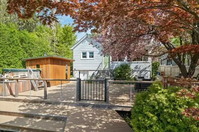 a backyard with a fence and a house at Cherry Blossom Lake House in Lake Peekskill