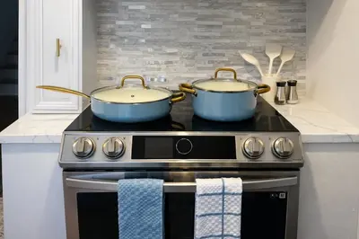two pots on top of a stove in a kitchen at Cherry Blossom Lake House in Lake Peekskill