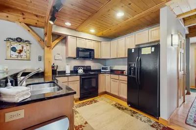 a kitchen with a black refrigerator and a sink at Grouse Lane 12C in Dover