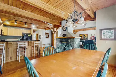 a dining room with a large wooden table and chairs at Grouse Lane 12C in Dover