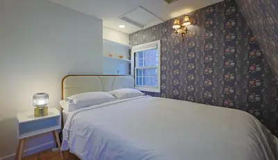 a bedroom with a white bed and a window at Long Island Nature Retreat with Peloton with Shared Pool in Glen Head