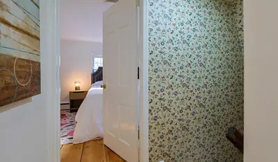 a room with a bedroom with a bed and a door at Long Island Nature Retreat with Peloton with Shared Pool in Glen Head