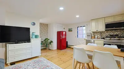a kitchen with a table and a red refrigerator at Long Island Nature Retreat with Peloton with Shared Pool in Glen Head