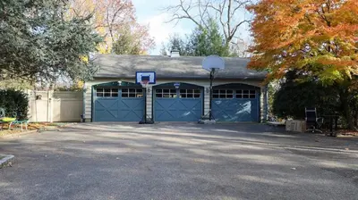 a garage with a basketball hoop on top of it at Long Island Nature Retreat with Peloton with Shared Pool in Glen Head