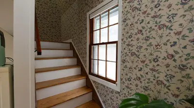 a stairway with a window and a staircase with a wall at Long Island Nature Retreat with Peloton with Shared Pool in Glen Head