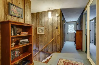 a hallway with wood paneling and a book shelf at 3 Mi to Mount Snow Spacious West Dover Home in West Dover