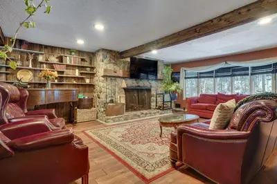 a living room with a red couch and a fireplace at 3 Mi to Mount Snow Spacious West Dover Home in West Dover