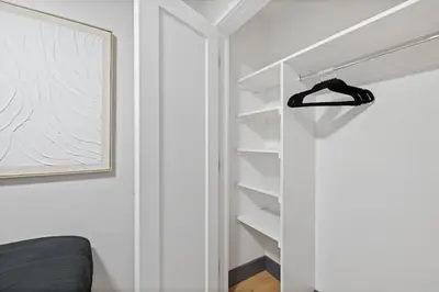 a bedroom with a closet with white walls at Luxury Brand New 3BED Gem 20 Minutes to NYC in Jersey City