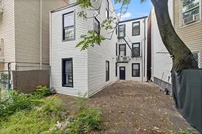 an empty driveway in front of a house at Luxury Brand New 3BED Gem 20 Minutes to NYC in Jersey City