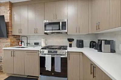 a kitchen with a stove and a microwave at Luxury Brand New 3BED Gem 20 Minutes to NYC in Jersey City