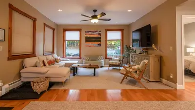 a living room with a couch and a table at Luxe Lakefront Paradise! King Beds, Private Dock, Gourmet Kitchen, Theatre and Game Room!