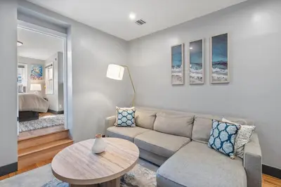 a living room with a couch and a table at Luxury and Modern Apt with Patio only 10 Min to Times Square in Jersey City