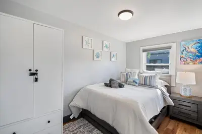 a white bedroom with a bed and a window at Luxury and Modern Apt with Patio only 10 Min to Times Square in Jersey City