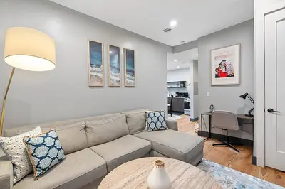 a living room with a couch and a table at Luxury and Modern Apt with Patio only 10 Min to Times Square in Jersey City