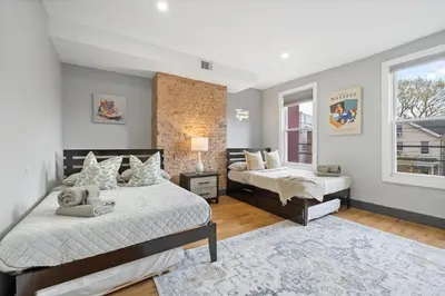 a bedroom with two beds and a window at Luxury and Chic 2BR 2BA Apt only 15 Mins to NYC & Hoboken in Jersey City