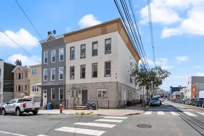 a building on the corner of a city street at New and Beautiful 2BR Apt in Prime Spot 20 Min to NYC in Jersey City
