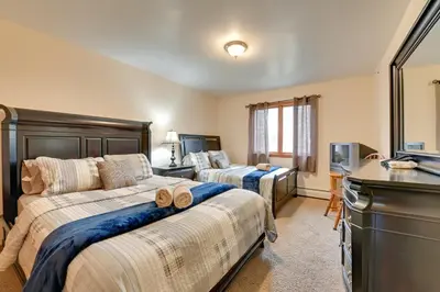 a bedroom with two beds and a television in it at Walk to Hunter Village! Family Ski Retreat with Deck in Lanesville