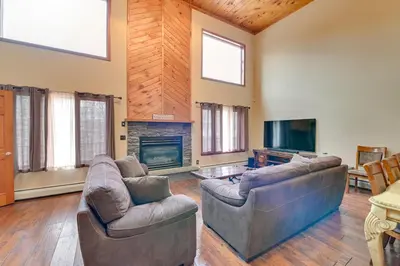 a living room with two couches and a fireplace at Walk to Hunter Village! Family Ski Retreat with Deck in Lanesville