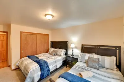 a bedroom with two beds and a couch in it at Walk to Hunter Village! Family Ski Retreat with Deck in Lanesville