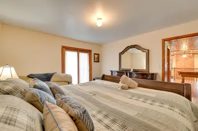 a bedroom with a large bed and a mirror at Walk to Hunter Village! Family Ski Retreat with Deck in Lanesville