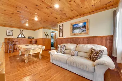 a living room with a couch and a table at Walk to Hunter Village! Family Ski Retreat with Deck in Lanesville