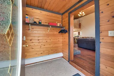 a pivot door in a room with a wooden wall at Less Than 1 Mi to Hunter Mtn Skiing Family-Friendly Stay! in Lanesville