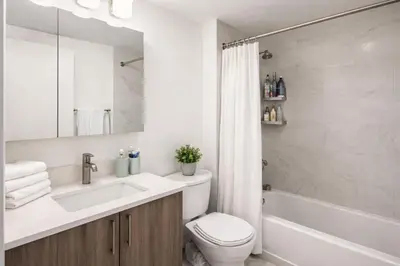 a bathroom with a sink and a toilet and a tub at Stylish Downtown Brooklyn Apartment Near Subway & Manhattan in Brooklyn