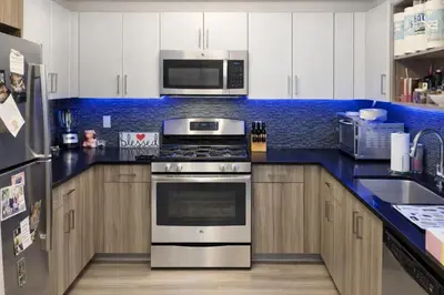 a kitchen with a stove and a microwave at Stylish Downtown Brooklyn Apartment Near Subway & Manhattan in Brooklyn