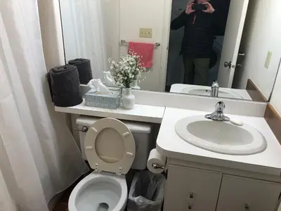a person taking a picture of a bathroom with a toilet and sink at Lakeridge Litchfield townhouse pool tennis skiing in Torrington