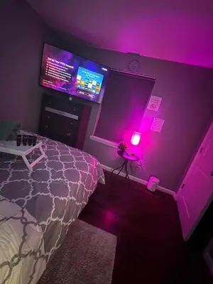 a bedroom with a bed and a purple wall at Cozy 3-Bedroom Apartment in Newark near NYC in Newark