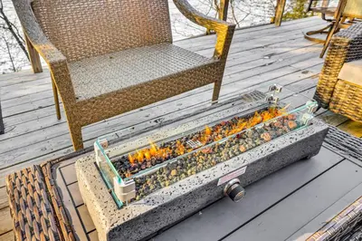 a container of lady bugs sitting on a deck at Lakefront Cottage with Dock, Hot Tub and Fire Pit in Greentown