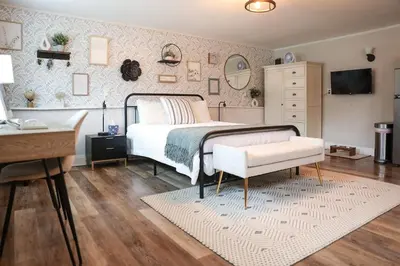 a bedroom with a bed and a table and a desk at Modern Cozy Studio in East Windsor