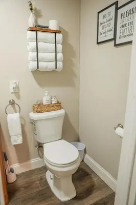 a bathroom with a white toilet and towels at Modern Cozy Studio in East Windsor