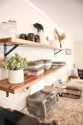a kitchen with wooden shelves and a sink at Modern Cozy Studio in East Windsor