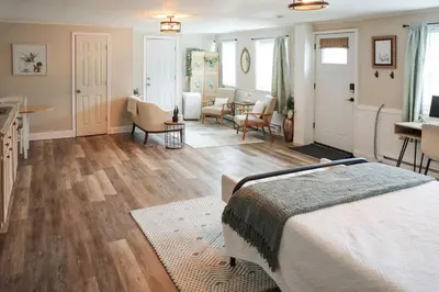 a bedroom with a bed and a living room at Modern Cozy Studio in East Windsor