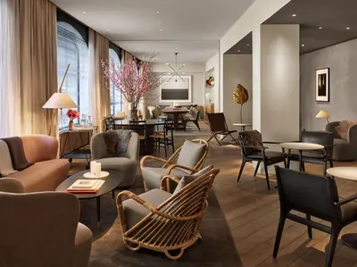 a lobby with chairs and tables and a living room at 11 Howard, New York, a Member of Design Hotels in New York