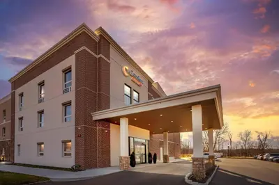 a building with people standing outside of it at Comfort Suites Central Valley - Woodbury in Central Valley