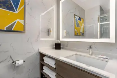a bathroom with a sink and a mirror at Comfort Suites Central Valley - Woodbury in Central Valley